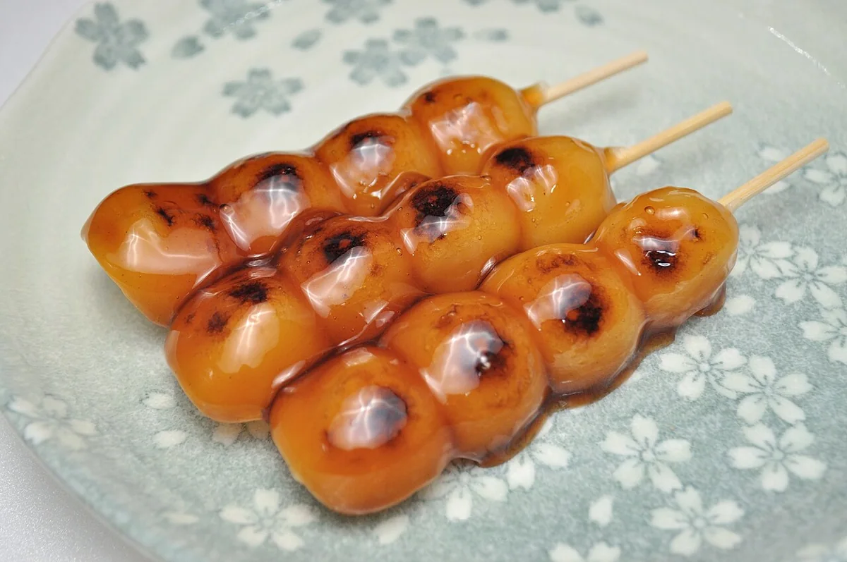 Mitarashi dango skewers covered in a glossy soy sauce glaze