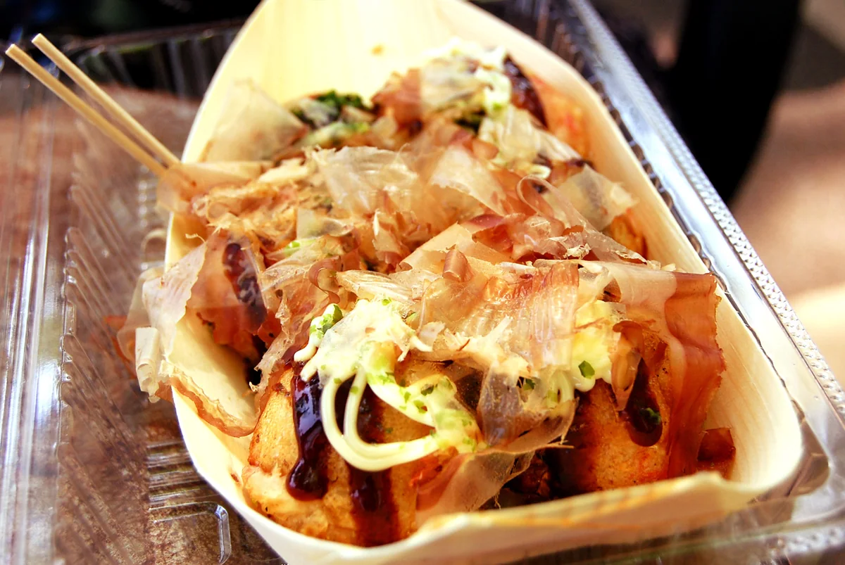 Round takoyaki topped with sauce and bonito flakes