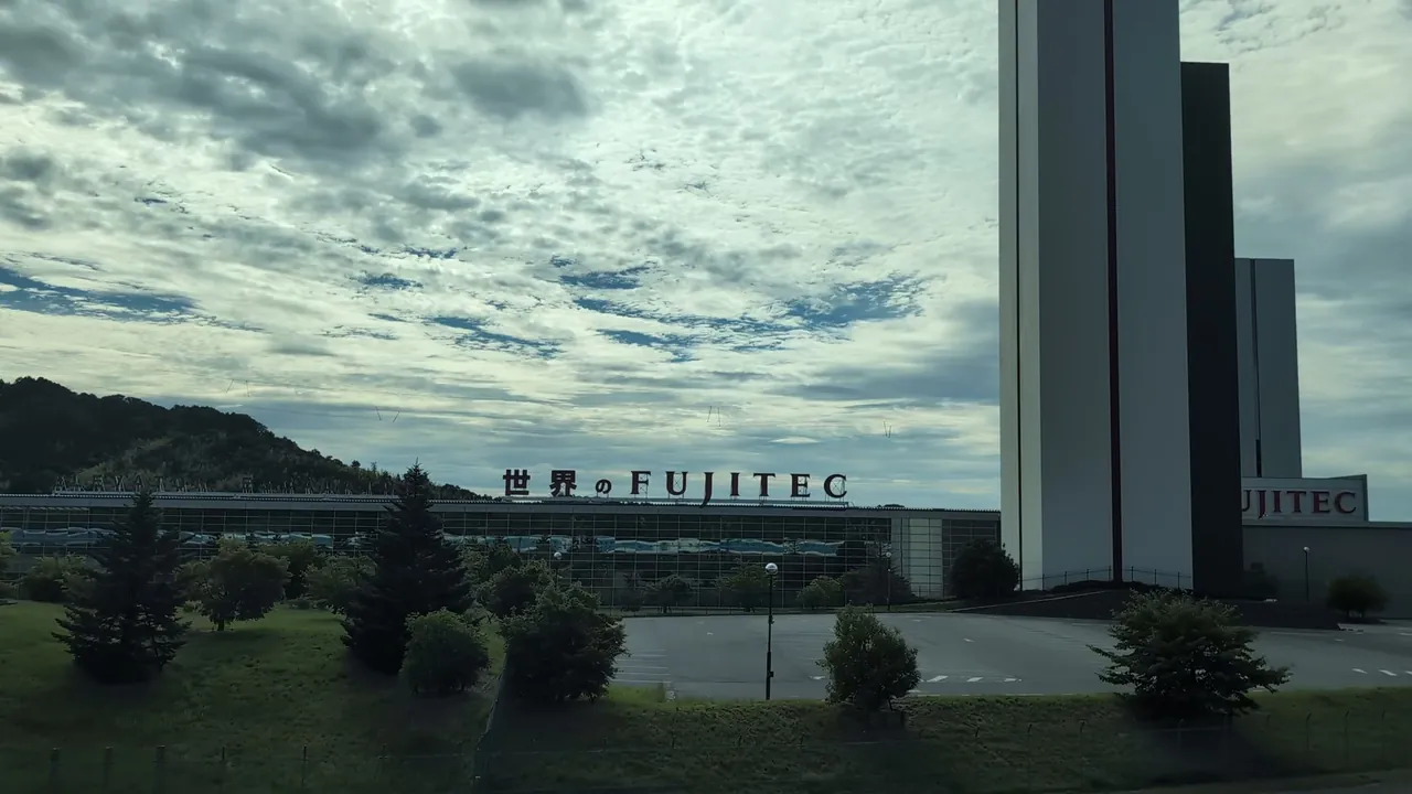 The FUJITEC building and research tower, with the Shinkansen reflected in the long glass