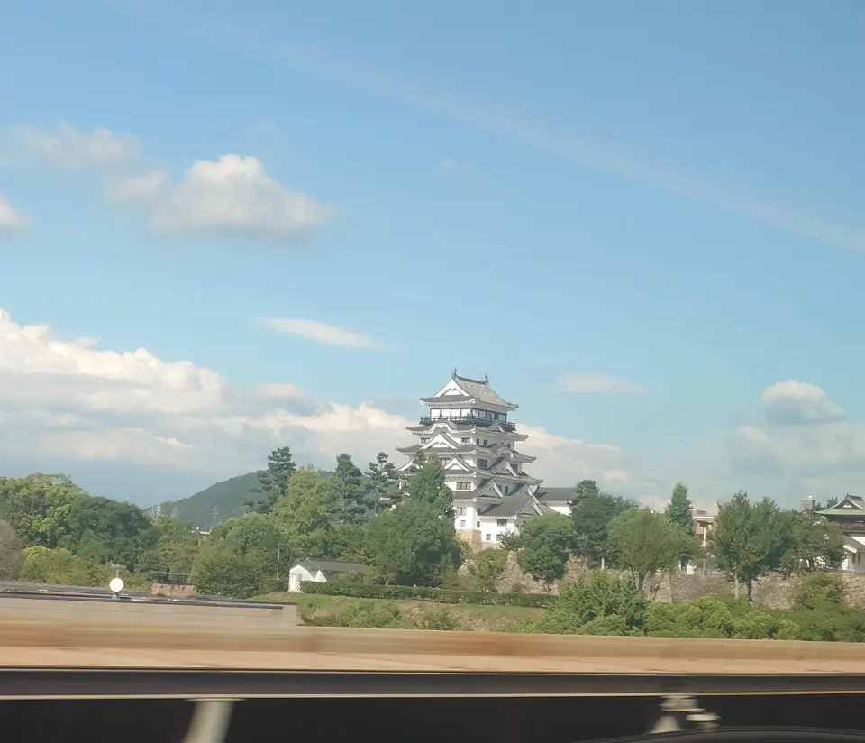 The keep and stone walls of Fukuyama Castle seen from the Shinkansen window
